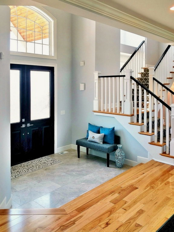 Contemporary Entranceway with Elegant Stained Double Doors, Neutral Tile, and Hickory Hardwood Floor Built Exclusively by Morgan Homes of Western New York, Inc.