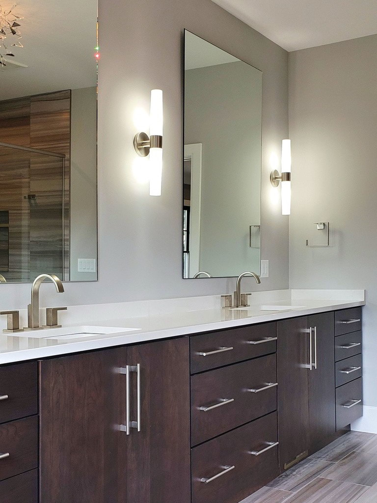 Transitional Master Bathroom with Elegant Lighting, Custom Cabinetry, and Unique Freestanding Tub Built Exclusively by Morgan Homes of Western New York, Inc.