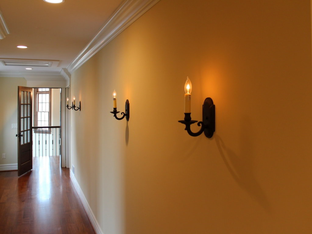 Updated Hallway with Crown-Molded Ceiling, Traditional Wall Sconces, and Walnut Hardwood Floor Built Exclusively by Morgan Homes of Western New York, Inc.