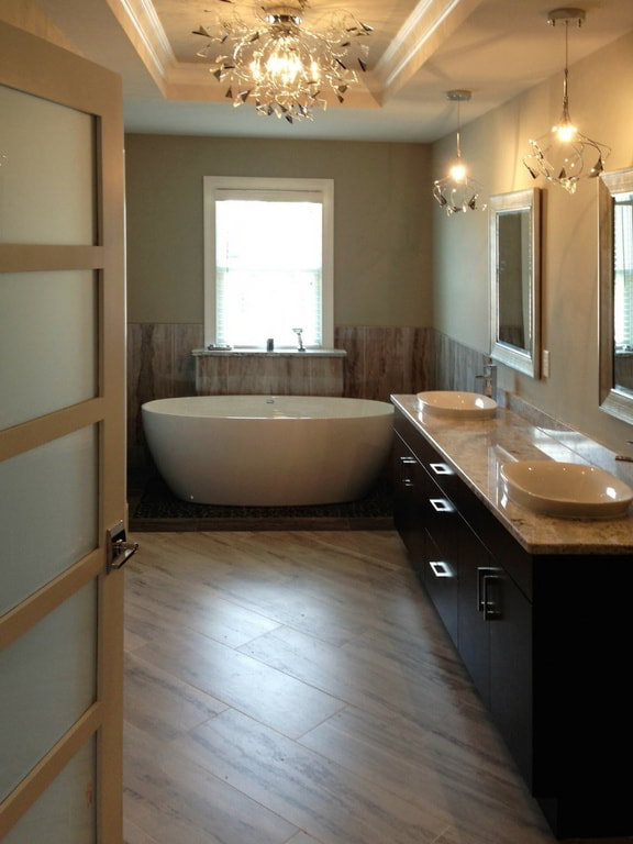 Master Bathroom with Pendant Lighting, Custom Cabinetry Accommodating Double Oval Vessel Sinks, and Modern Freestanding Soaking Tub Built Exclusively by Morgan Homes of Western New York, Inc.